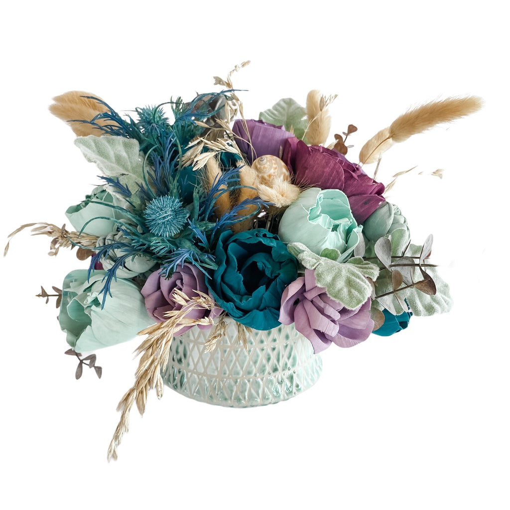 mermaid sola wood flower arrangement centerpiece in purple and teal by pine and petal market