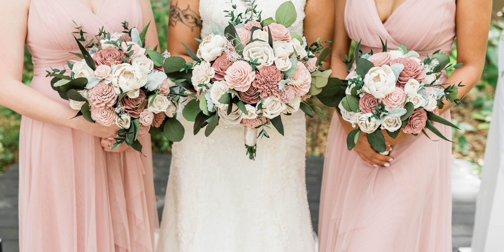 sola wood flower wedding bouquets in dusty rose and blush being held by bridesmaid and bride in dusty rose dresses