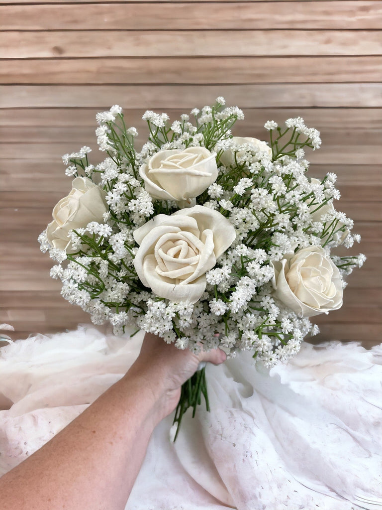 white rose and babies breath sola wood flower bridal bouquet being held