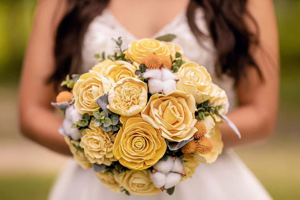 yellow lemon inspired custom sola wood flower bridal wedding bouquet being held by bride from pine and petal weddings