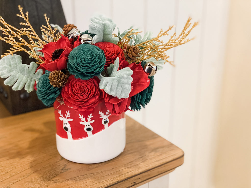 reindeer sola flower arrangement with red and green for christmas decor