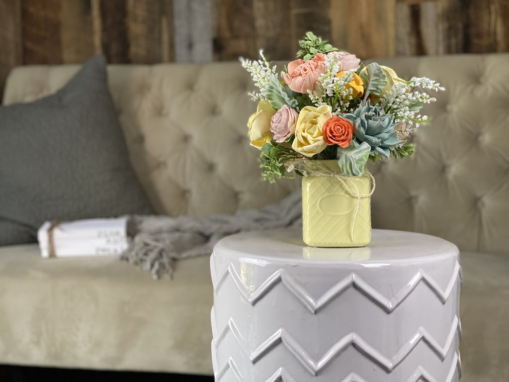 faux floral arrangement in yellow with succulents 