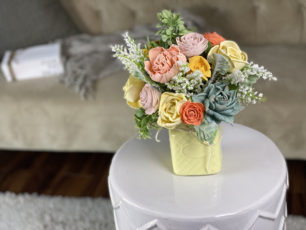 sola wood flower arrangement with succulents in yellow and peach