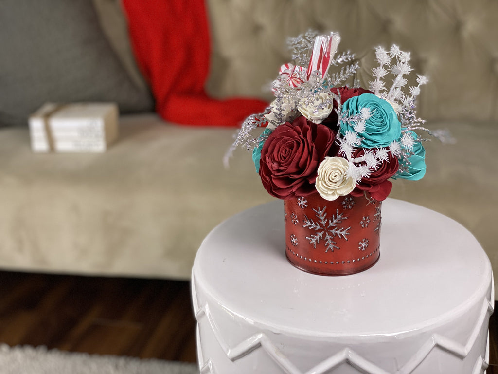 festive holiday sola wood flower centerpiece with red and teal flowers