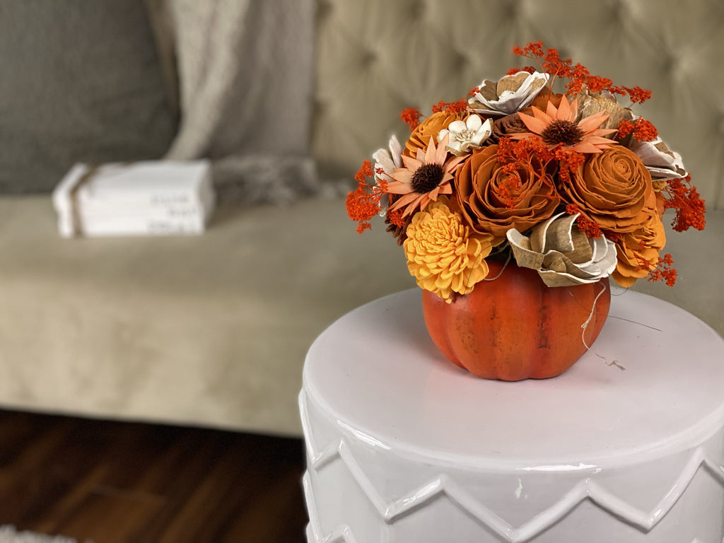 fall pumpkin sola wood flower arrangement for thanksgiving table in orange