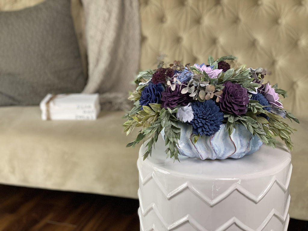 large garden dish arrangement made with sola wood flowers for garden wedding centerpiece in blue and purple with succulents