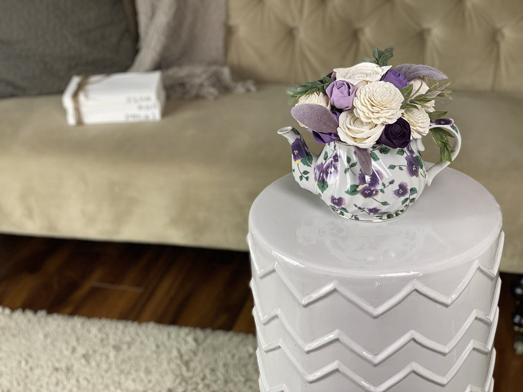 purple teapot sola wood flower arrangement by pine and petal market