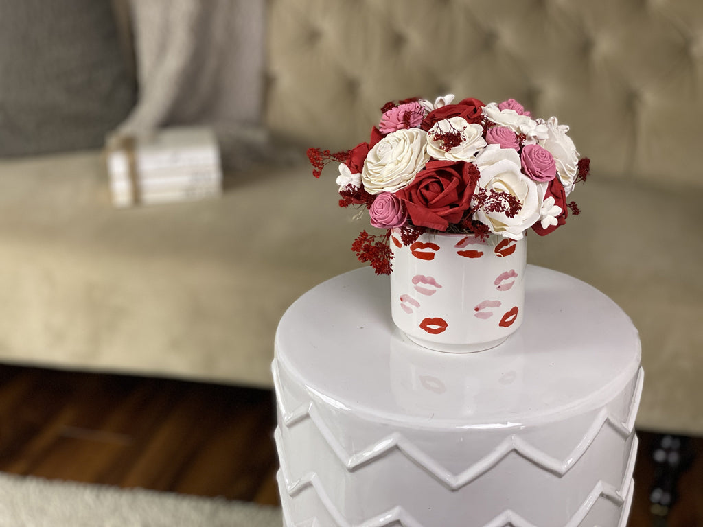 send her flowers that last with our delicate sola wood flower arrangements made with roses and arranged in a kisses! vase