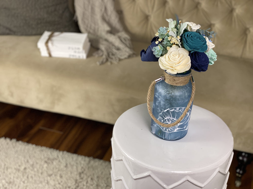 sola wood flower arrangement in blue bottle for beach house or beach decor