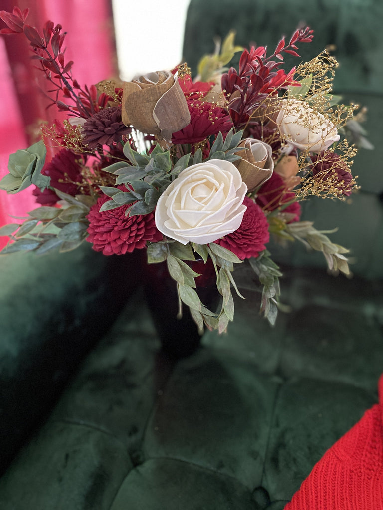 sola wood flower arrangement for christmas decorations with poinsettias and red vase