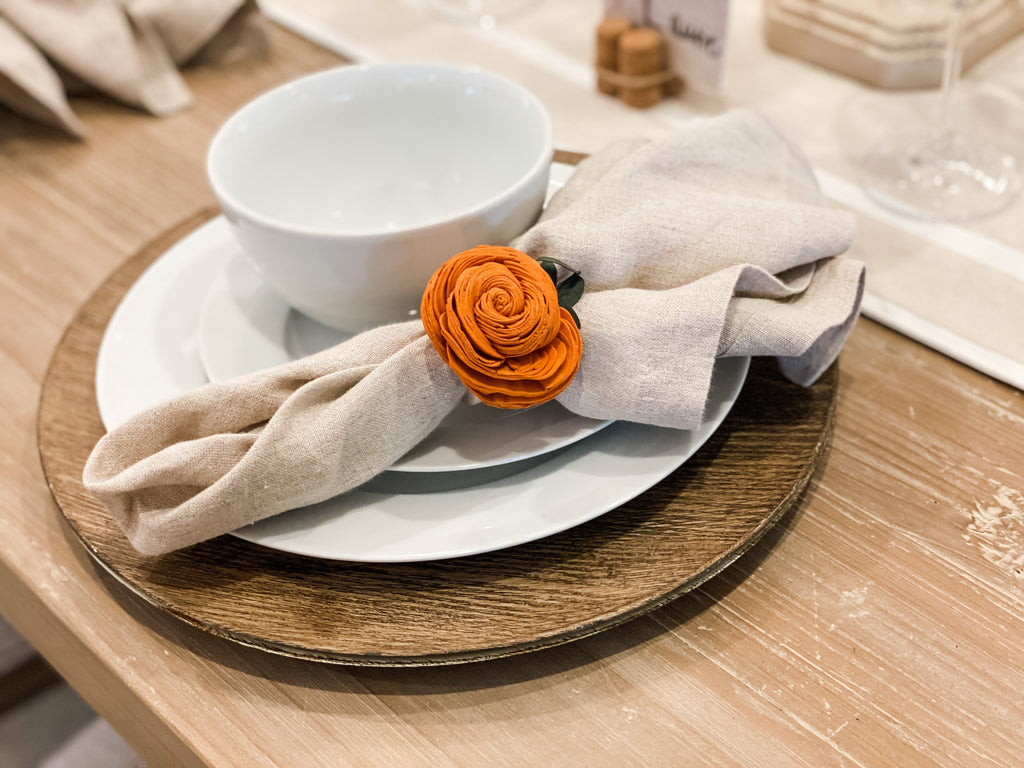 pine and petal market table decor of napkin rings made from pumpkin sola flowers