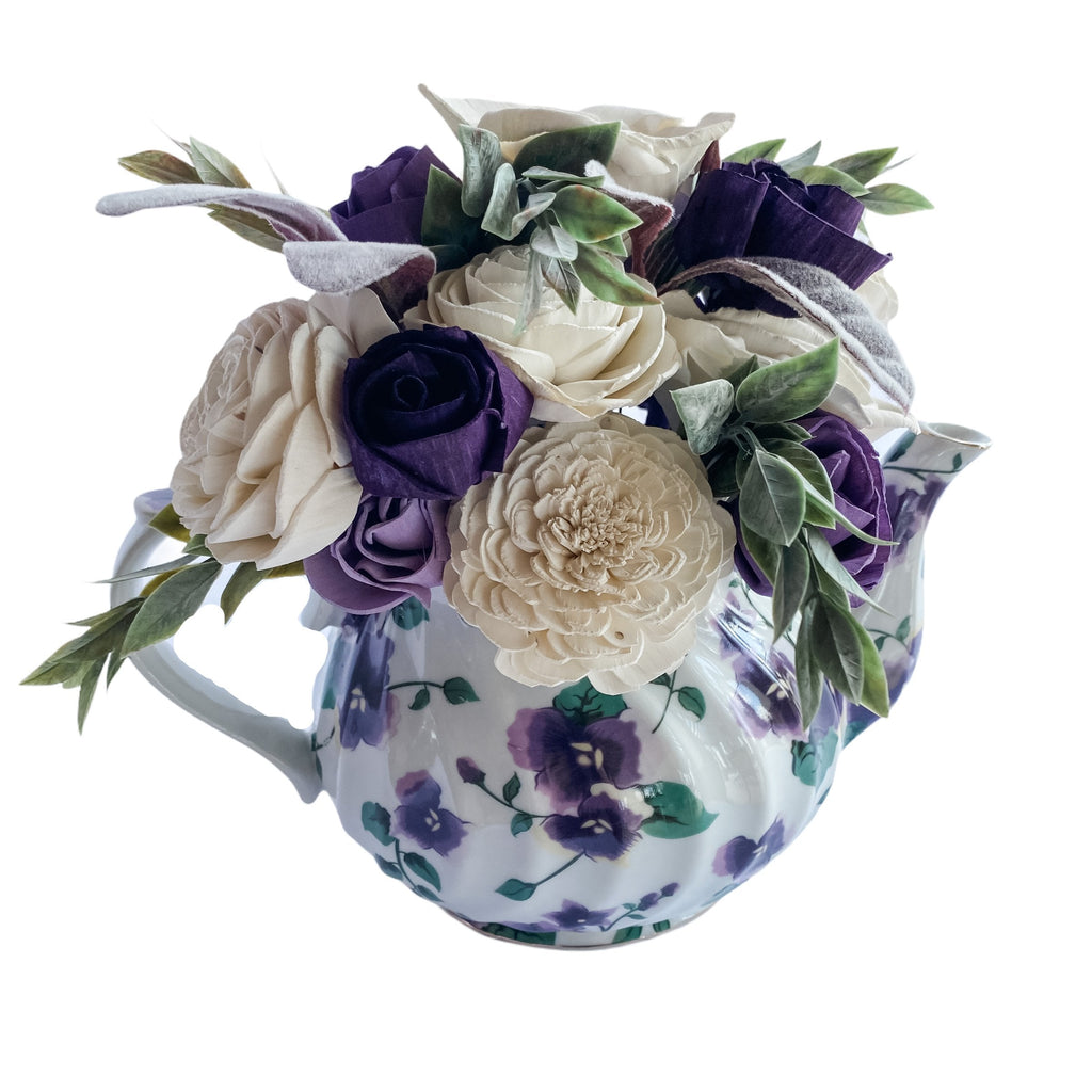 white and purple sola flower rose floral centerpiece in teapot