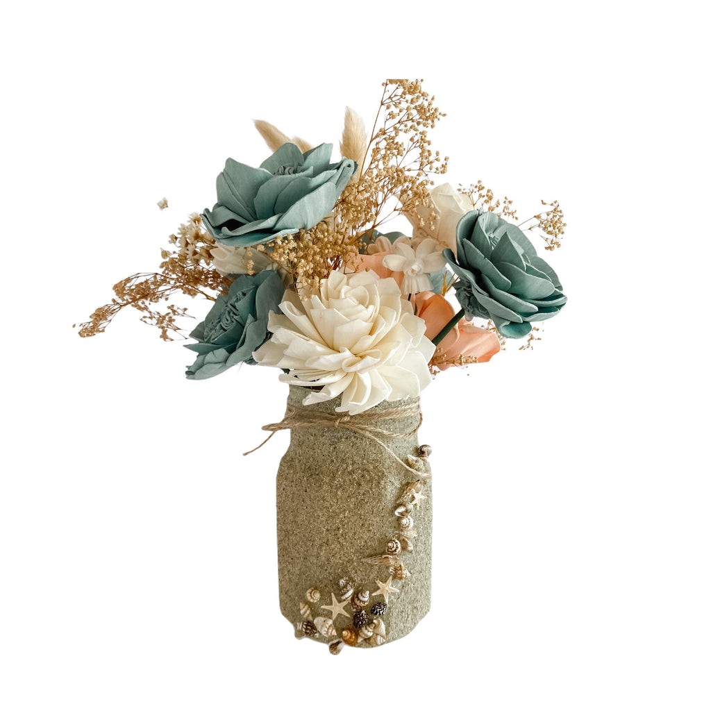 unique mason jar ideas with sand and shells for beachside wedding in coral and seafoam